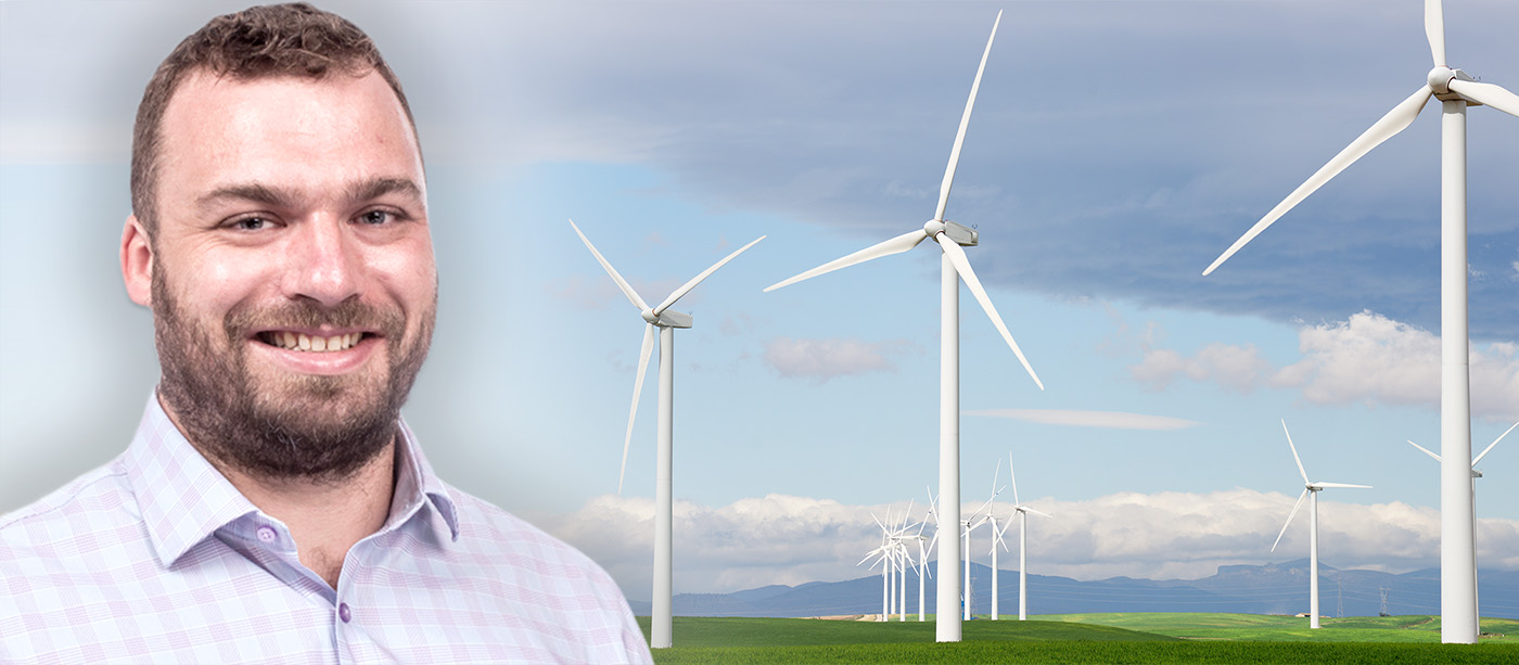 Illustrative photo with a man in front of windmills.