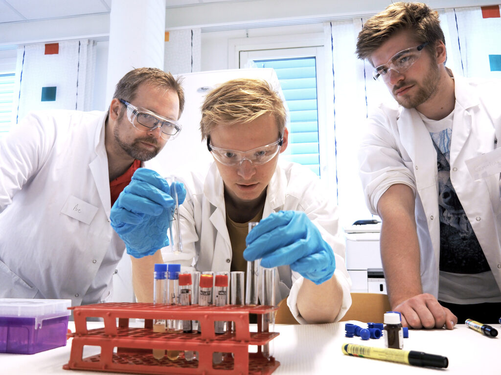 A picture of three men working in a lab.