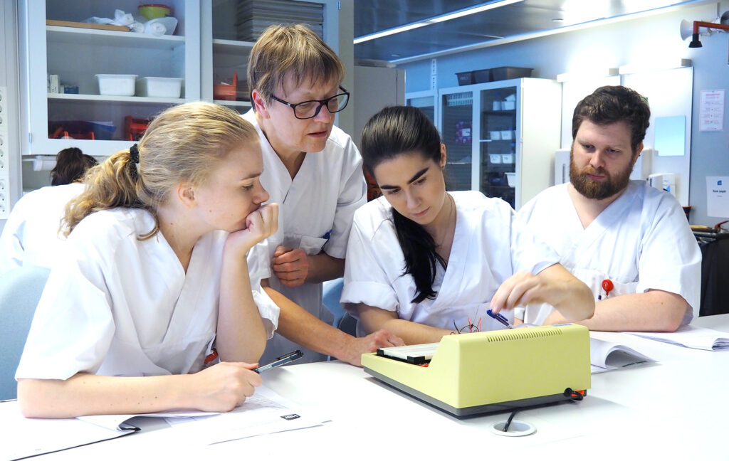 A picture of four people woeking in a lab.