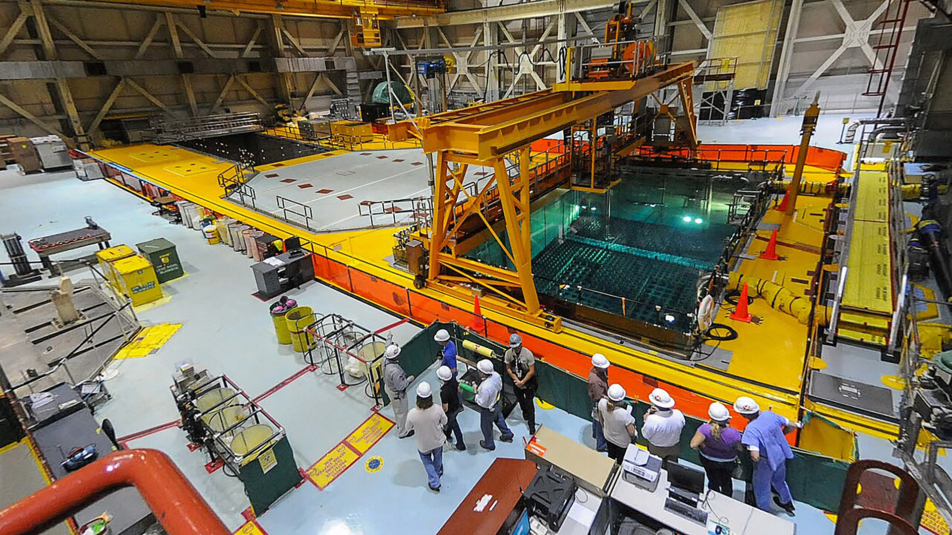 Overview of large lab with pool and people in hard hats. photo