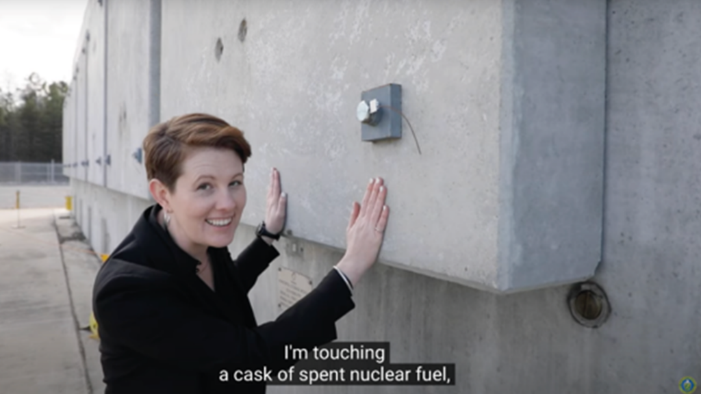 smiling person placing their hands on concrete. photo